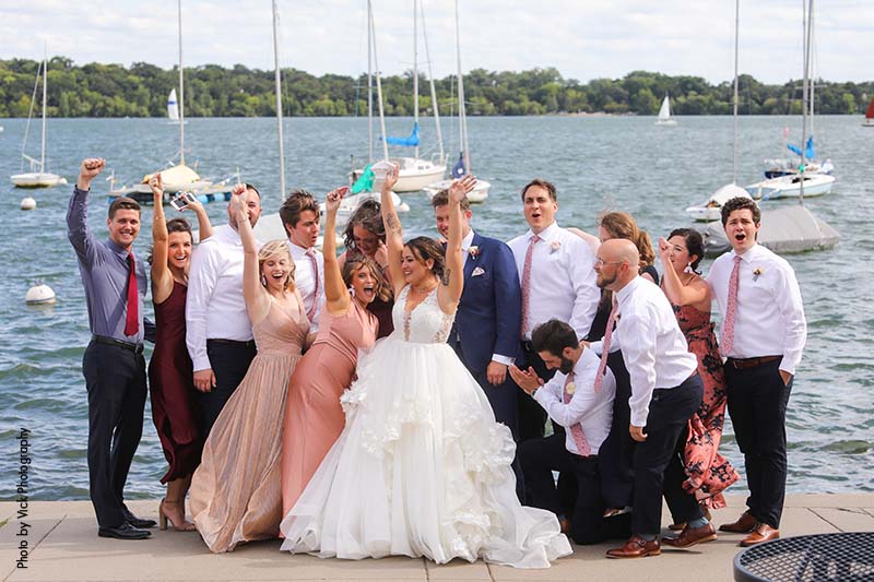 Wedding party standing on dock