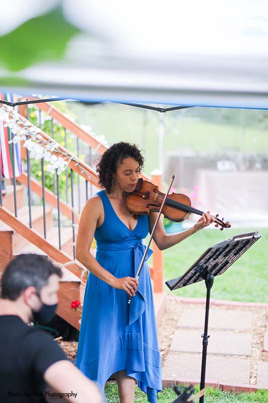 Violinist playing at backyard wedding reception