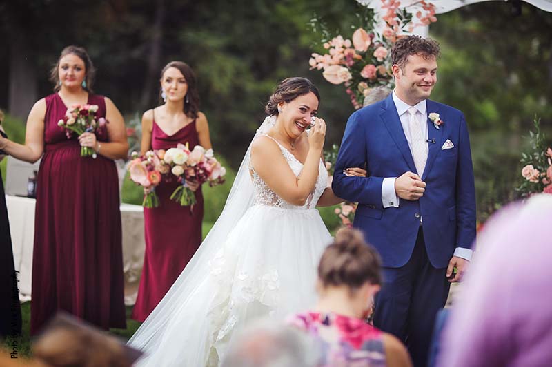 Bride crying during backyard micro wedding