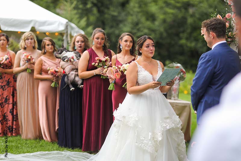 Bride reading her vows during a backyard micro wedding