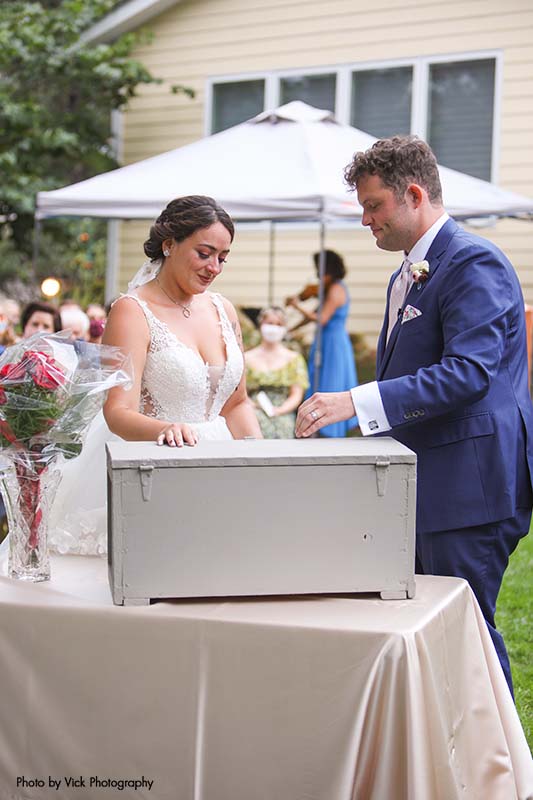 Bride and groom performing a wedding ritual at backyard wedding