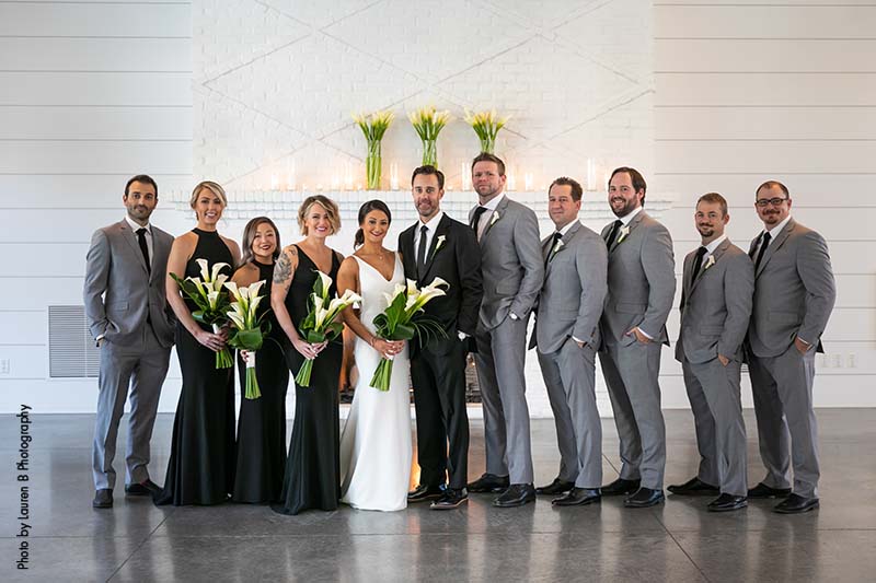 Groomsmen in gray suits and bridesmaids in black dresses