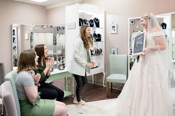 Bridal Consultant helps bride find dress at Bridal Aisle Boutique