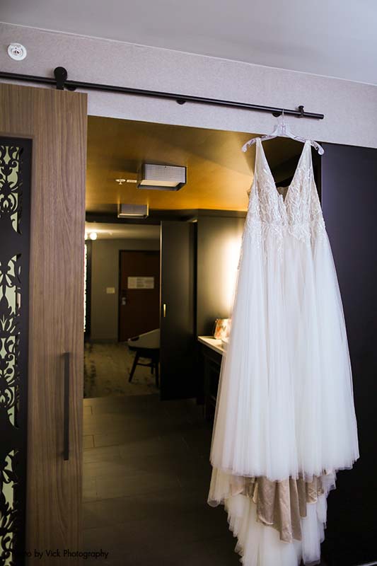 V-neck plus-size bridal gown hangs on hanger