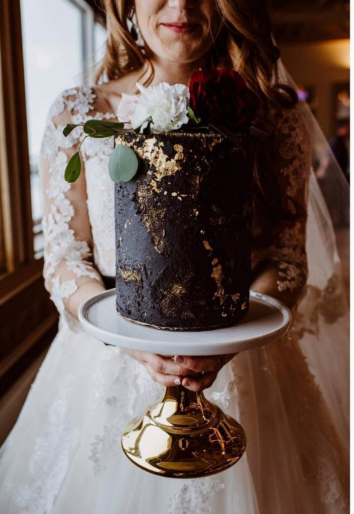 Single tier black wedding cake with gold details