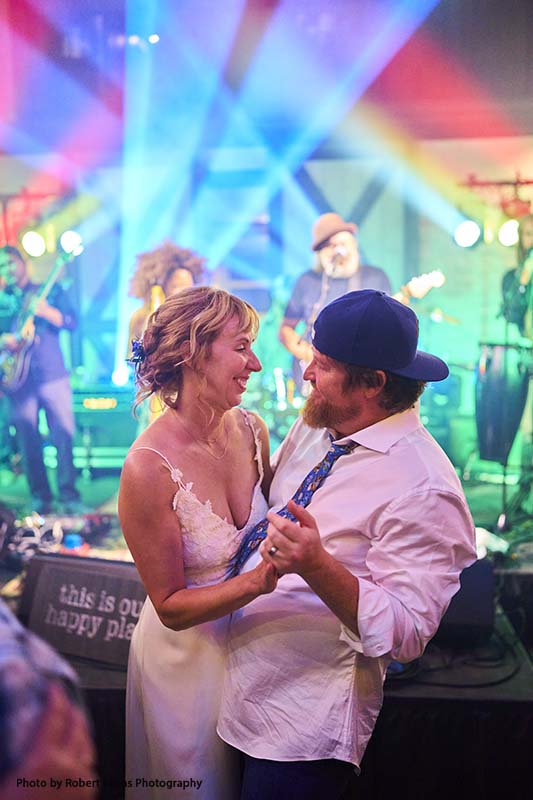 Bride and groom dance to live band at wedding