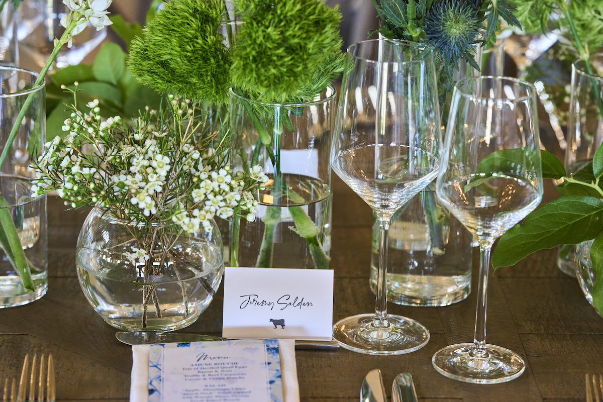 Wedding centerpiece with simple stemware and greenery