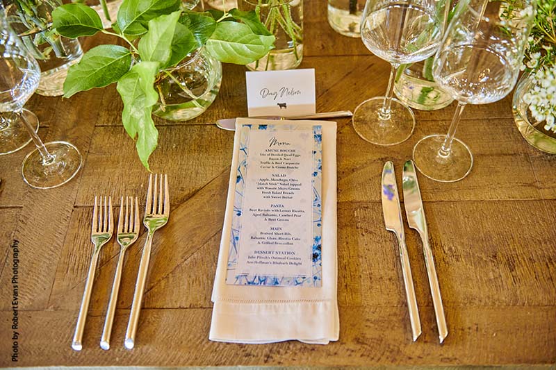 Wedding menu with four courses lays out wooden table
