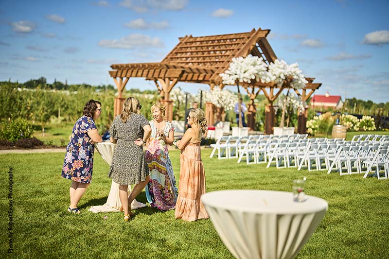 Guests enjoy wedding happy hour outside