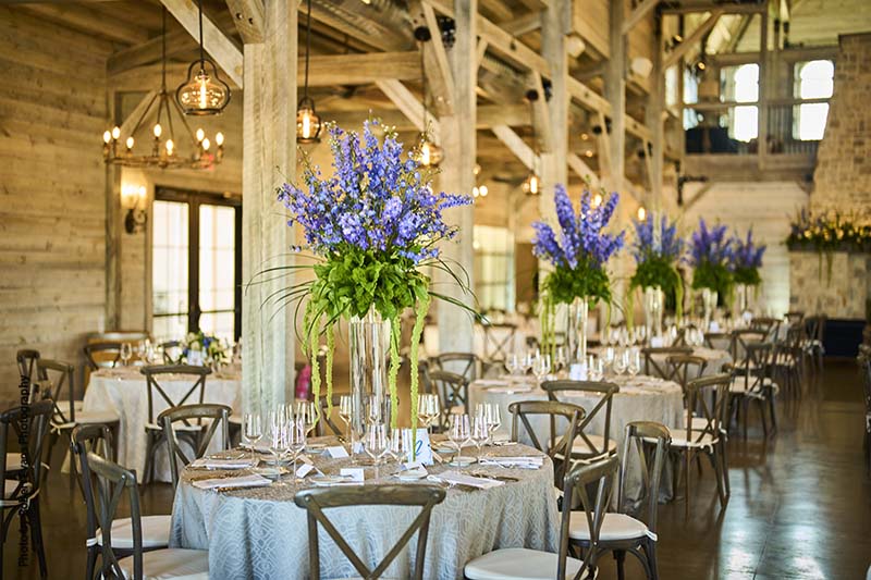 Tall wedding centerpieces with purple and green wildflowers