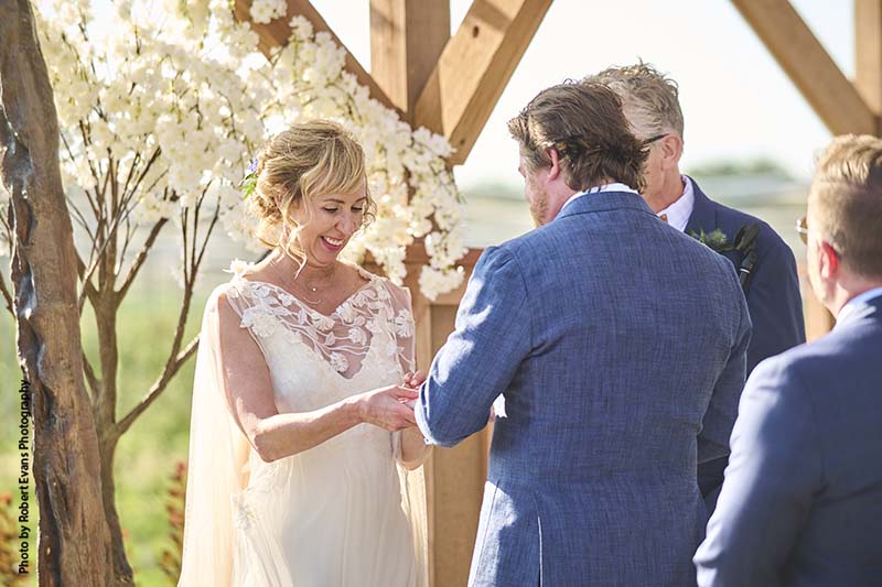 Bride and groom exchange vows in outdoor ceremony
