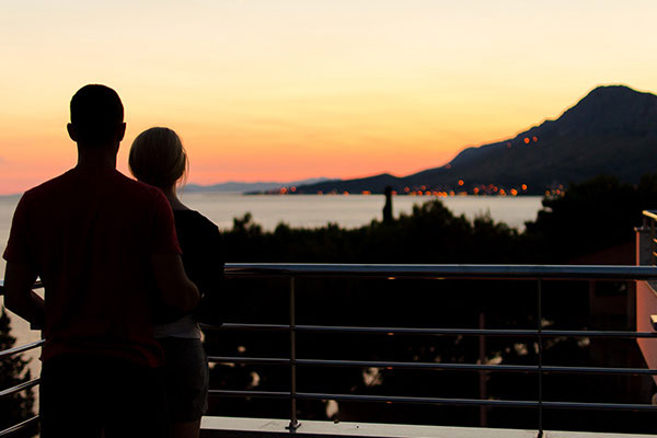 Couple watches sunset on honeymoon