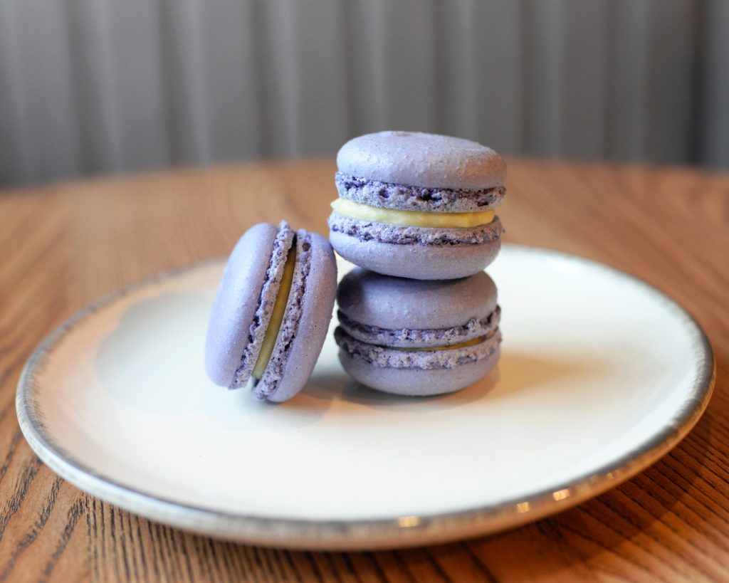 French Colorful Macarons Colorful Pastel Macarons on the plate in cafe Violet purple Macaron Lavender Macaron 2022 Pantone Color of the year