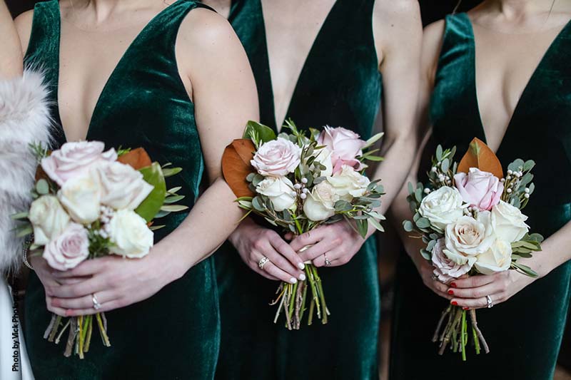 Assorted pastel rose and greenery bridesmaid bouquets