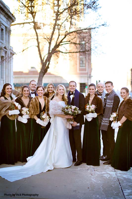 Bridesmaids in faux fur shall's and groomsmen in scarfs