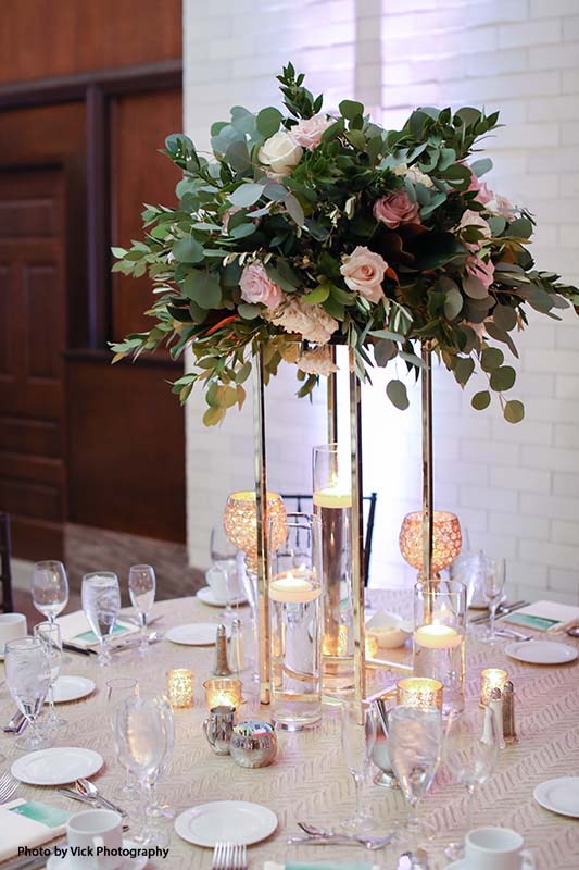 Tall floating rose and greenery wedding centerpiece