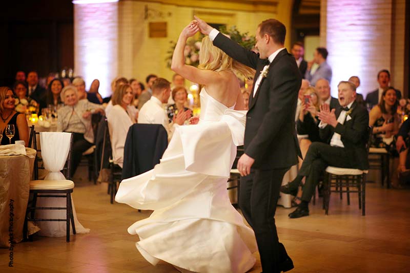 Fun bride and groom first dance in Minneapolis ballroom