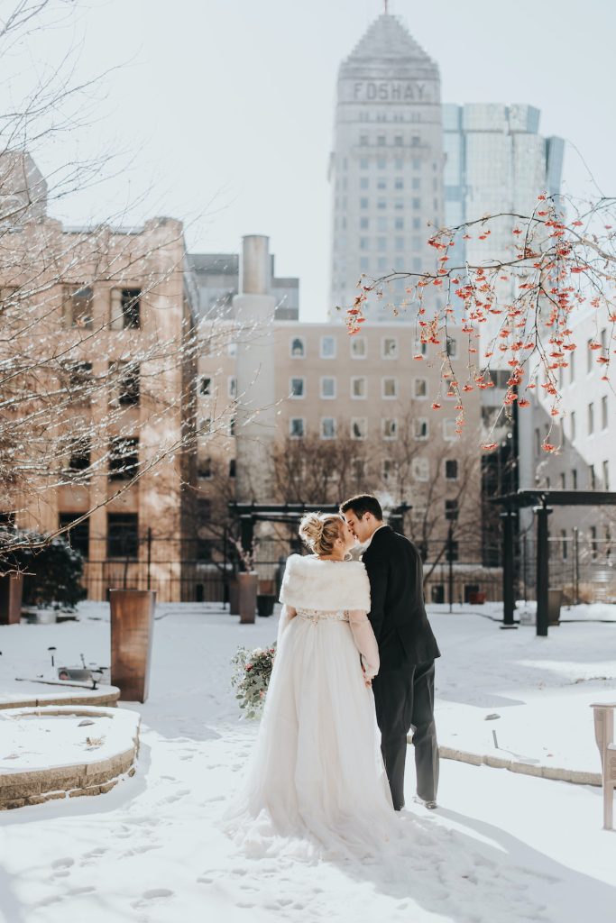 Bride and groom in Minneapolis walk through the snow