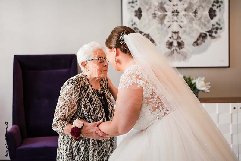 Grandmother seeing bride for the first time in wedding dress