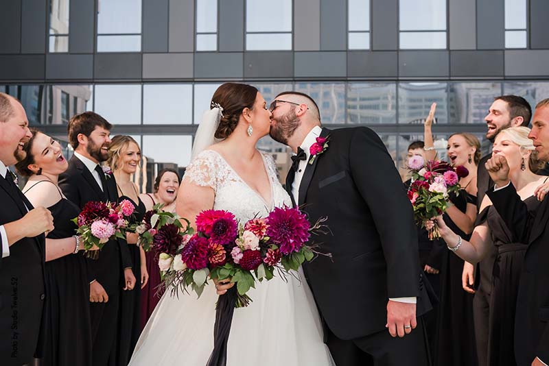 Bride and groom share first kiss at modern Minnesota wedding
