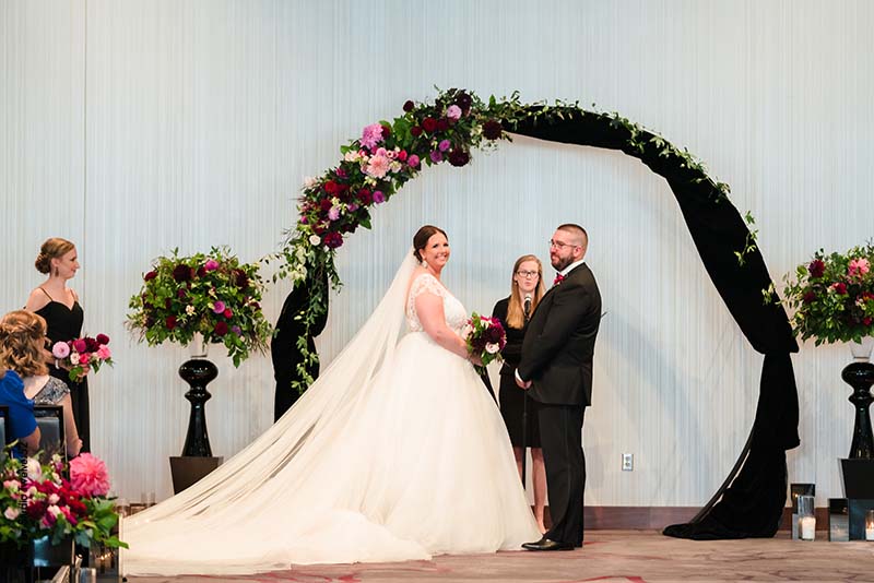 Black wedding arch with colorful flowers
