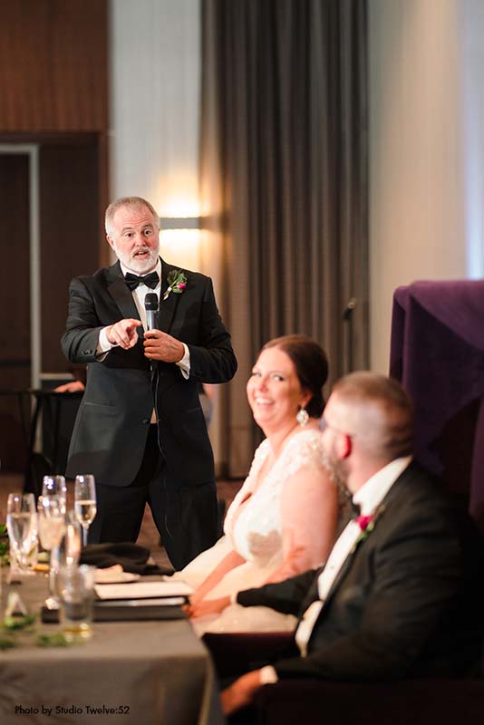 Father giving speech at modern wedding reception