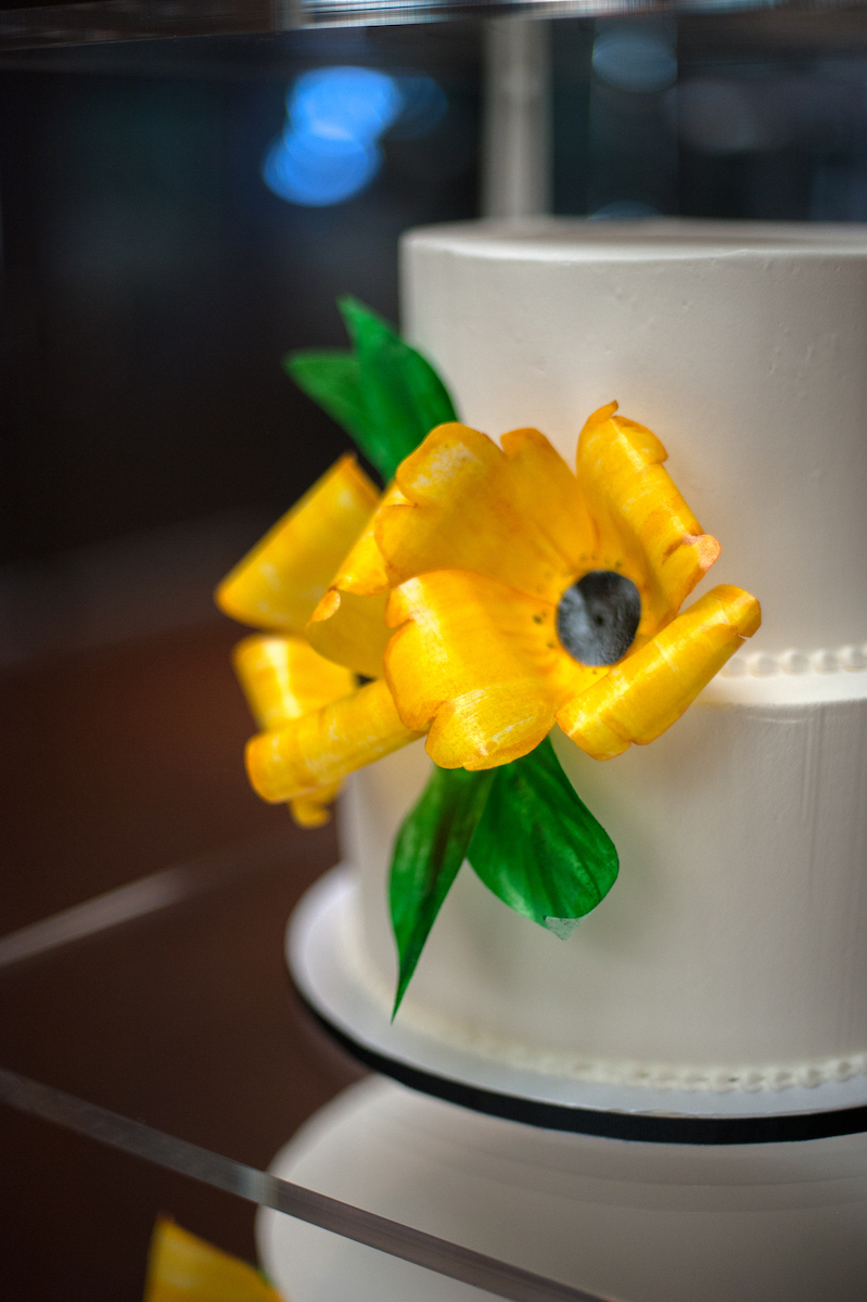 White wedding cake with bright yellow flowers