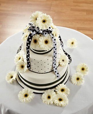 Black and white dotted wedding cake with daisies