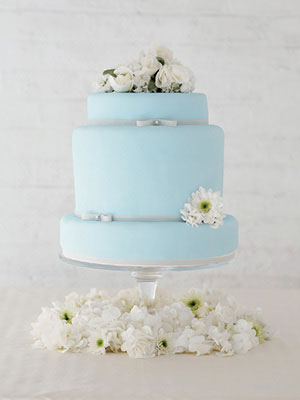 Light blue wedding cake with white flowers