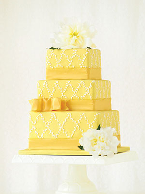 Square-tier wedding cake with yellow frosting