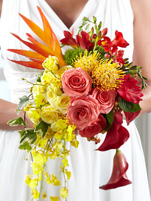 Cascading tropical bridal bouquet with pink and yellow roses