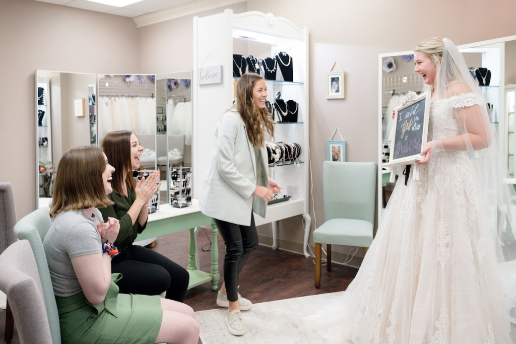 Bride tries on gowns at Bridal Aisle Boutique bridal salon in the Twin Cities