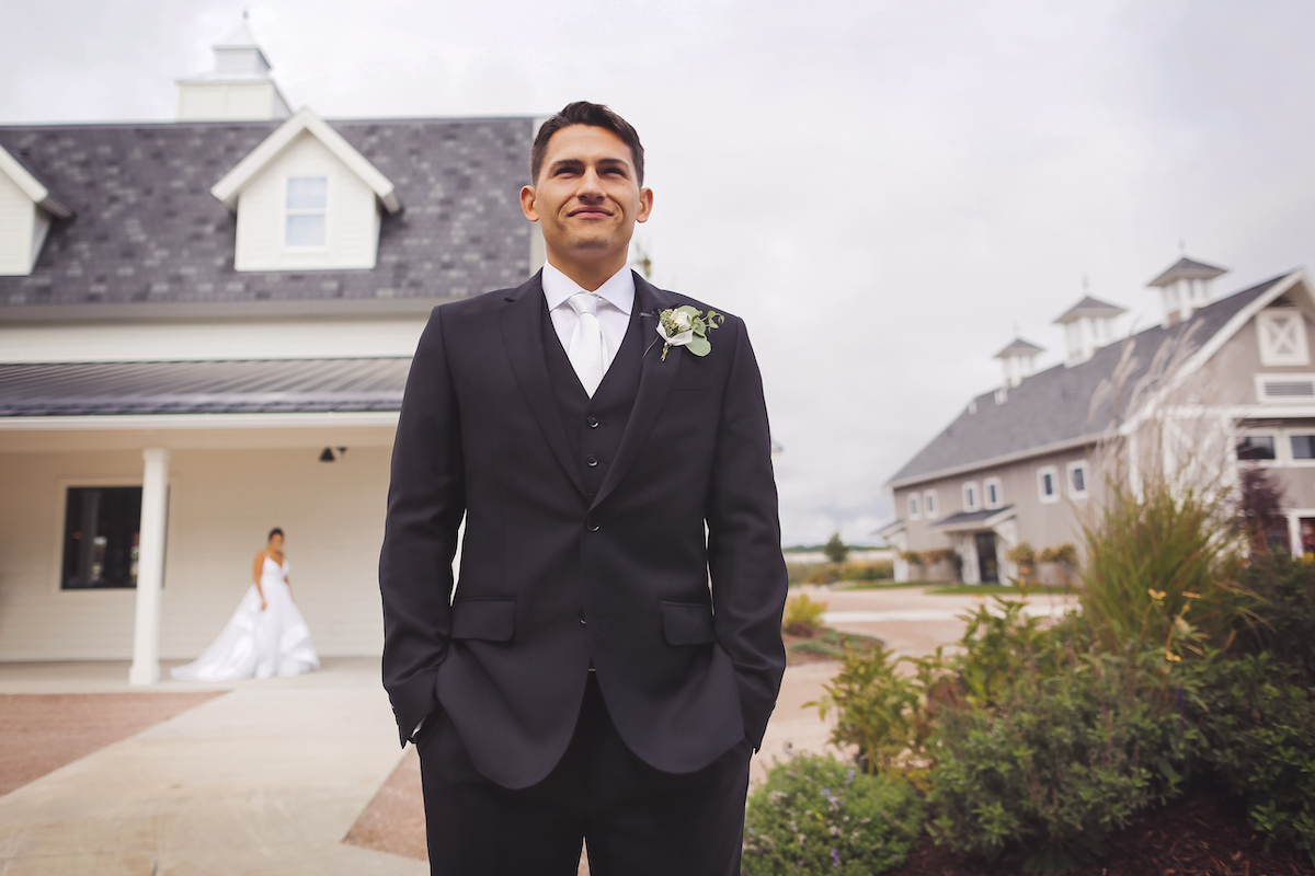 Groom standing waiting to see bride for the first time on their wedding day