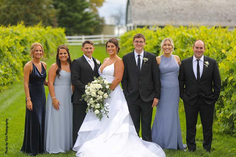 Bride and groom with family at outdoor wedding