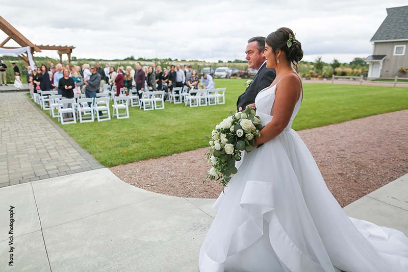 Father walks bride down aisle at outdoor Minnesota wedding