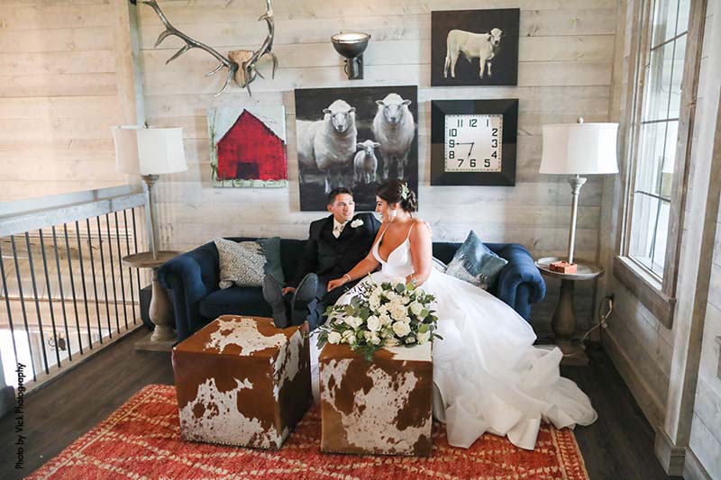Bride and groom pose in Minnesota barn