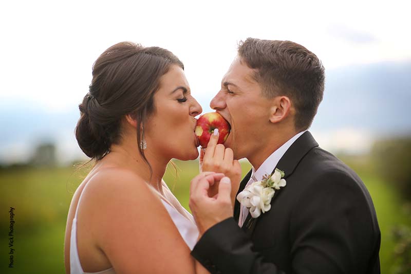 Bride and groom share an apple at Minnesota fall wedding