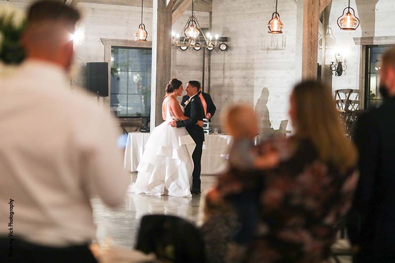 Bride and groom first dance at barn wedding