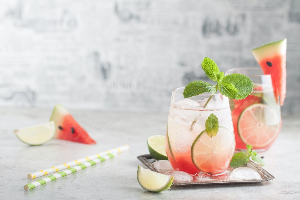 Fresh watermelon lemonade with lime, ice and mint for the summer party on the metal tray