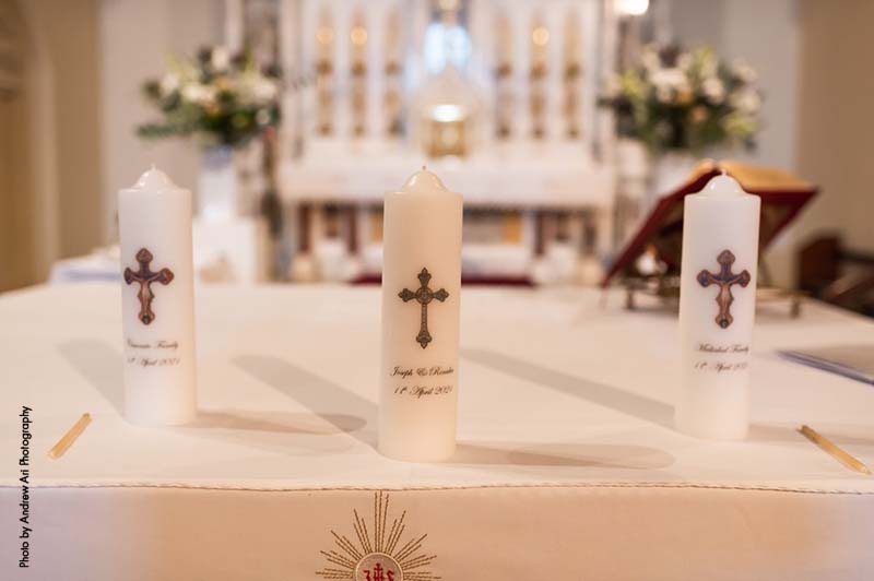 Catholic wedding candles sit on altar