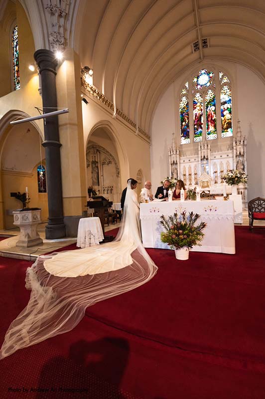 Bride and groom stand at altar for traditional Catholic wedding