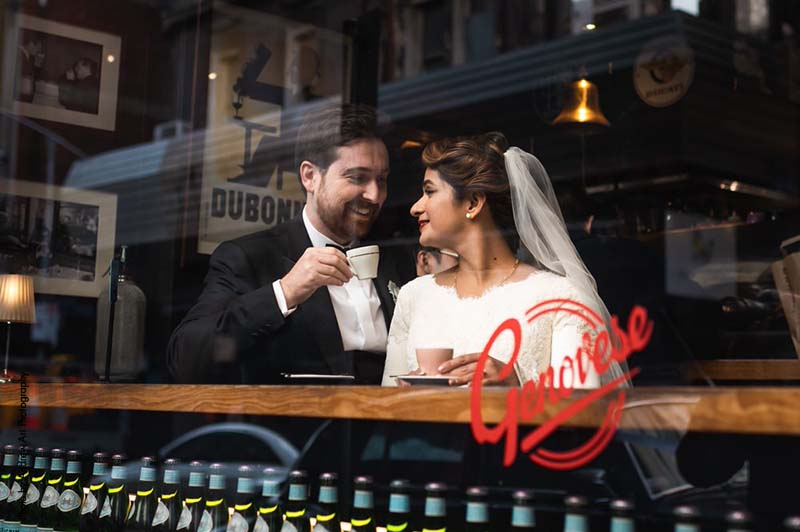Bride and groom sit inside Italian restaurant