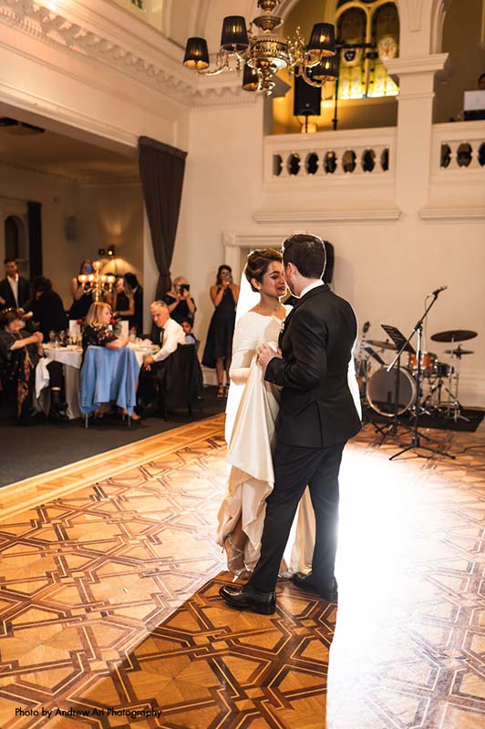 Bride and groom share dance in a ballroom