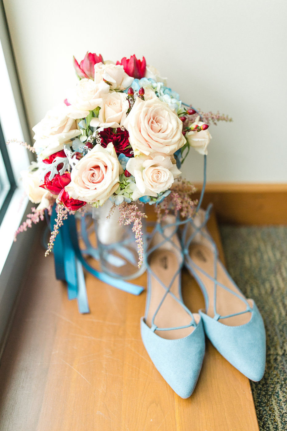 Blue wedding shoes sit aside a bright wedding bouquet for a classic daytime wedding