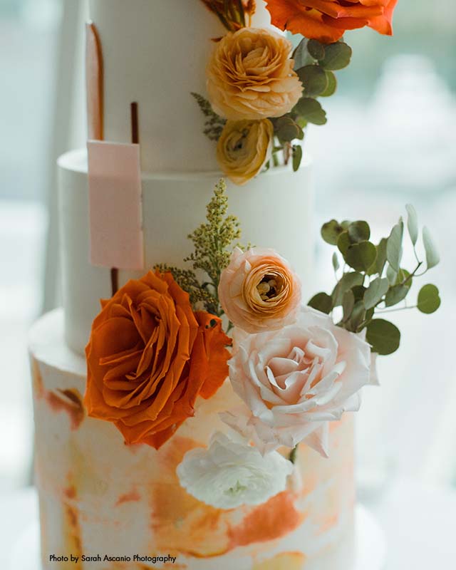 Modern orange and yellow floral wedding cake