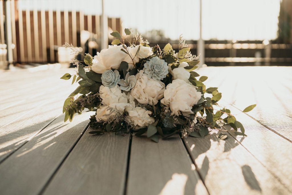 Peony bridal bouquet with greenery and pastel blue roses  summer wedding flowers