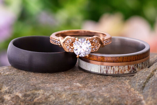 Custom wedding rings with rose gold, deer antler, and wood
