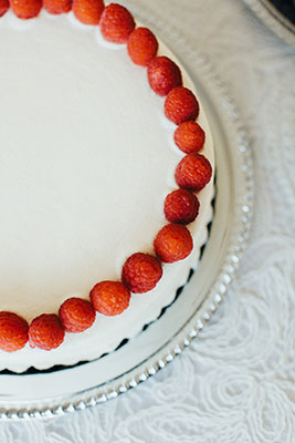 Small white wedding cake with raspberries