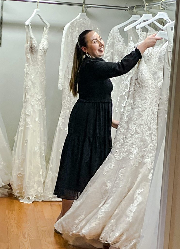 Bridal salon consultant helps bride find dress at The Wedding Shoppe