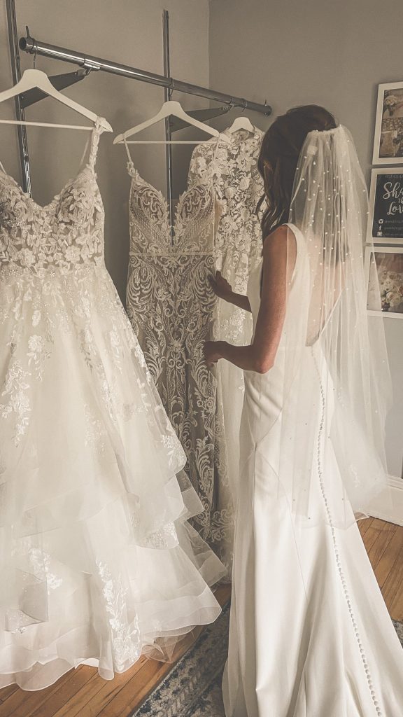 Bride tries on bridal gowns at The Wedding Shoppe